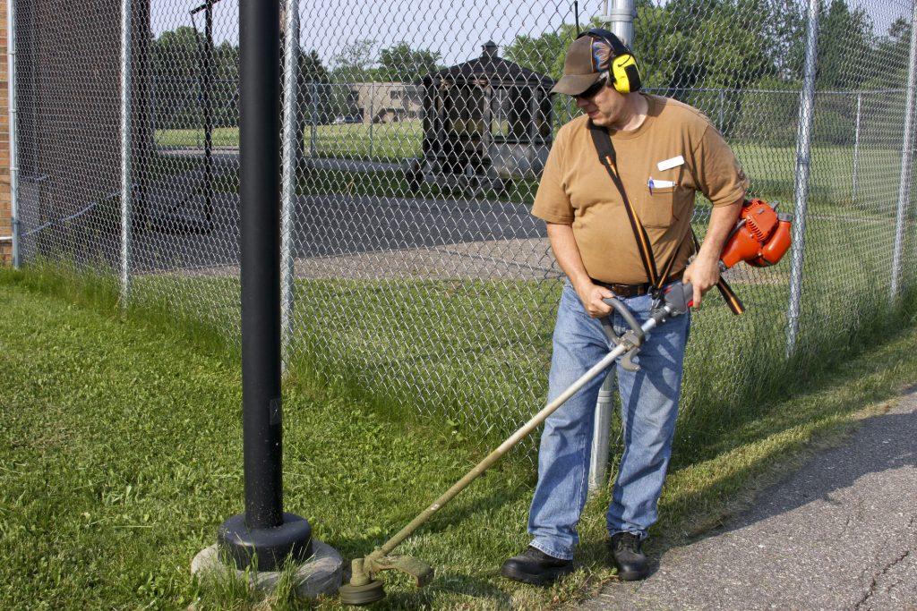 Cutting weeds with a weed whacker or brush cutter